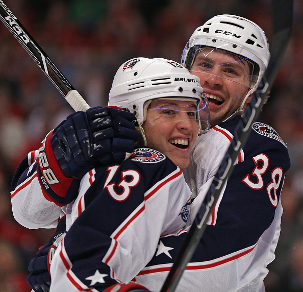 CHICAGO, IL - MARCH 27: Cam Atkinson #13 of the Columbus Blue Jackets gets a hug from teammate Boone Jenner #38 after s coring a goal in the first period against the Chicaho Blackhawks at the United Center on March 27, 2015 in Chicago, Illinois. (Photo by Jonathan Daniel/Getty Images)