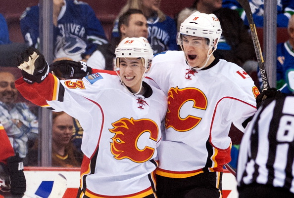 VANCOUVER, BC - APRIL 13: Johnny Gaudreau #53 of the Calgary Flames celebrates with teammate Joe Colborne #8 after scoring his first NHL goal against the Vancouver Canucks during the second period in NHL action on April 13, 2014 at Rogers Arena in Vancouver, British Columbia, Canada.  (Photo by Rich Lam/Getty Images)