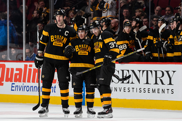 MONTREAL, QC - JANUARY 19:  Zdeno Chara #33 (left) Brad Marchand #63 (centre) and Patrice Bergeron #37 of the Boston Bruins (right) have a discussion during the NHL game against the Montreal Canadiens at the Bell Centre on January 19, 2016 in Montreal, Quebec, Canada.  The Boston Bruins defeated the Montreal Canadiens 4-1.  (Photo by Minas Panagiotakis/Getty Images)